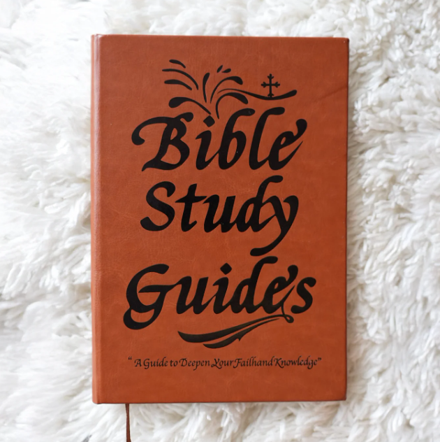 A brown book titled 'Bible Study Guides' resting on a white, fluffy surface.