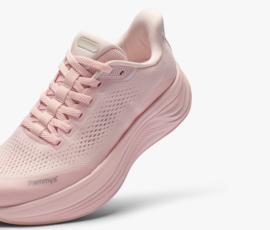 Pink athletic shoe with mesh design and thick sole on white background.
