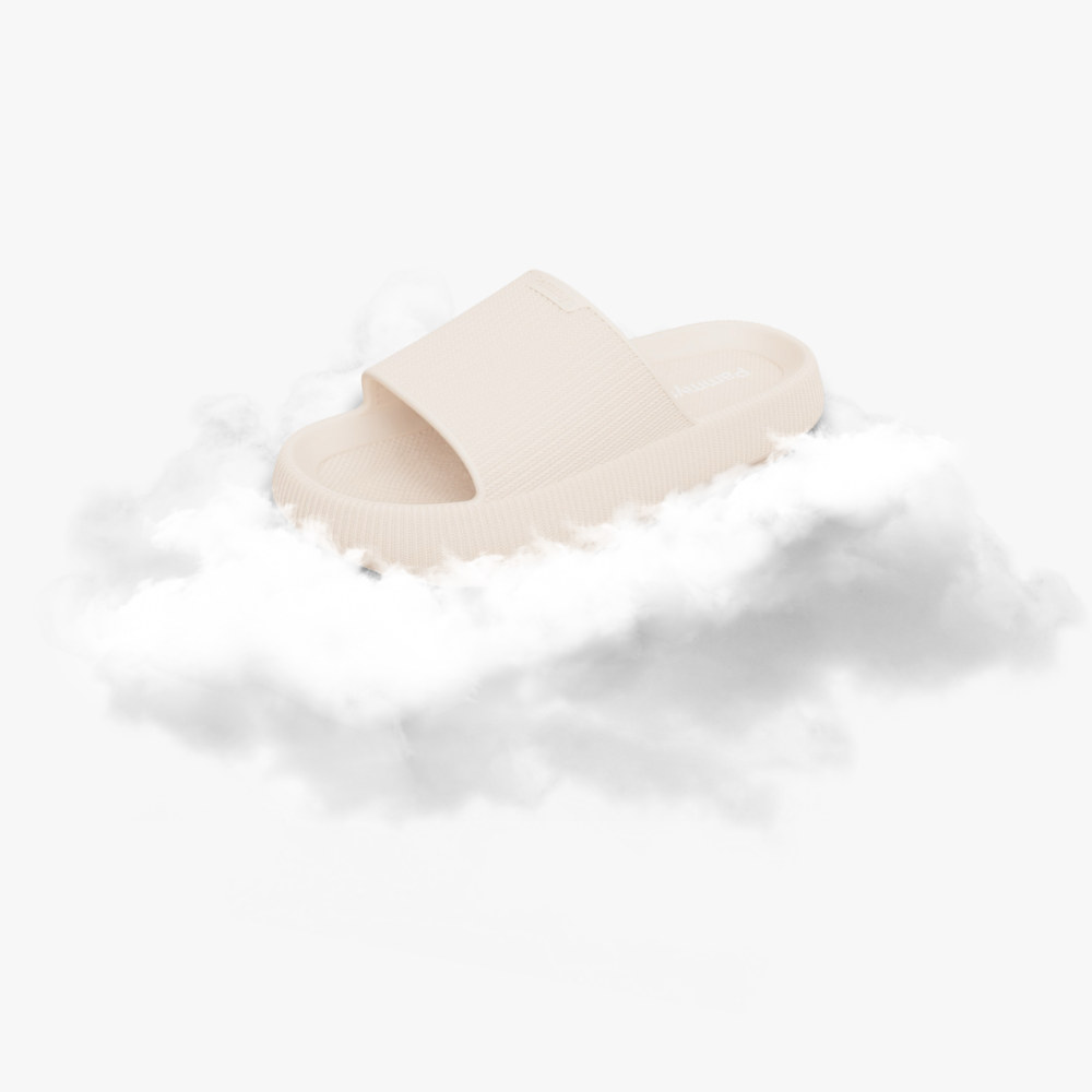 Light blue slide sandal resting on fluffy white clouds.