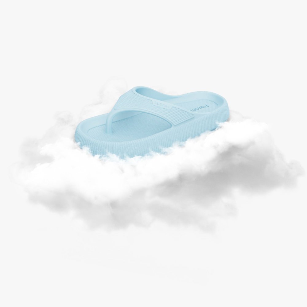 Light blue slide sandal resting on fluffy white clouds.