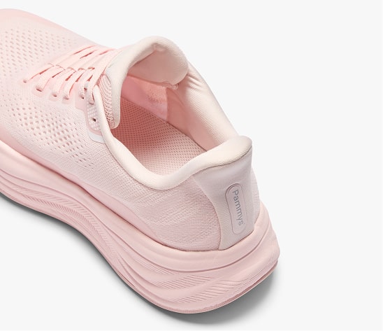 Pink athletic shoe with mesh design and thick sole on white background.