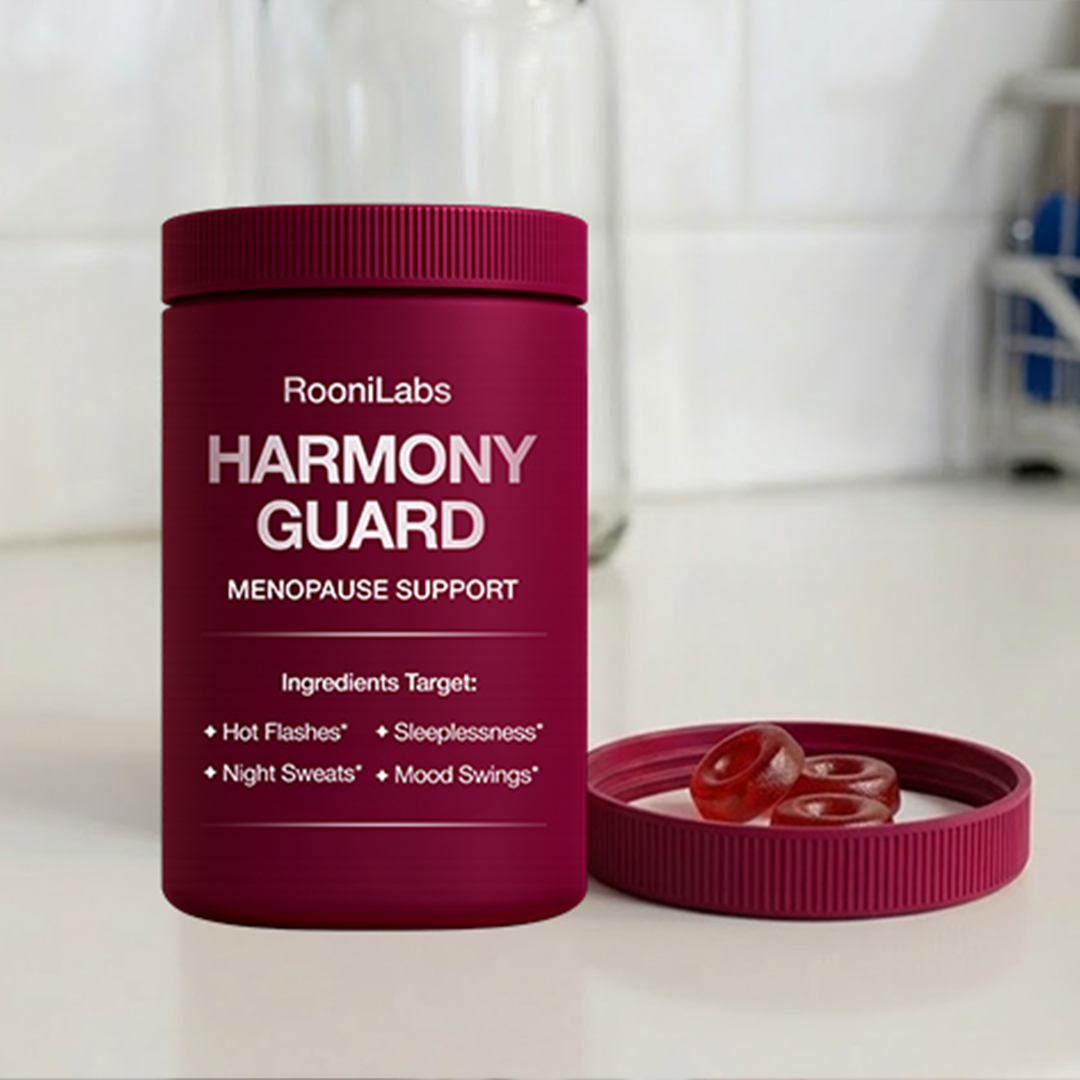A magenta bottle of Harmony Guard Menopause Support with three red, ring-shaped gummies in the lid.