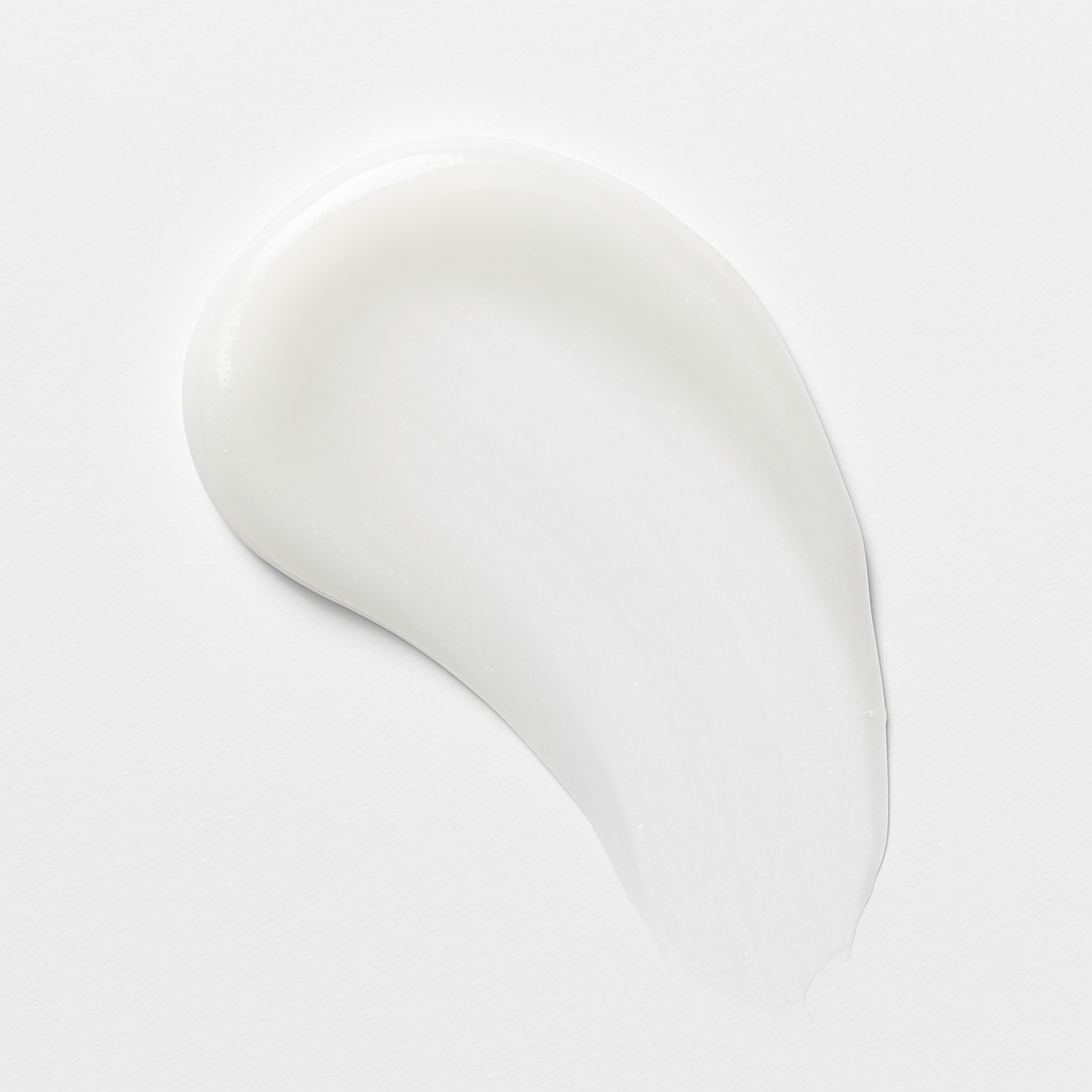 White cream smear on a plain white background.
