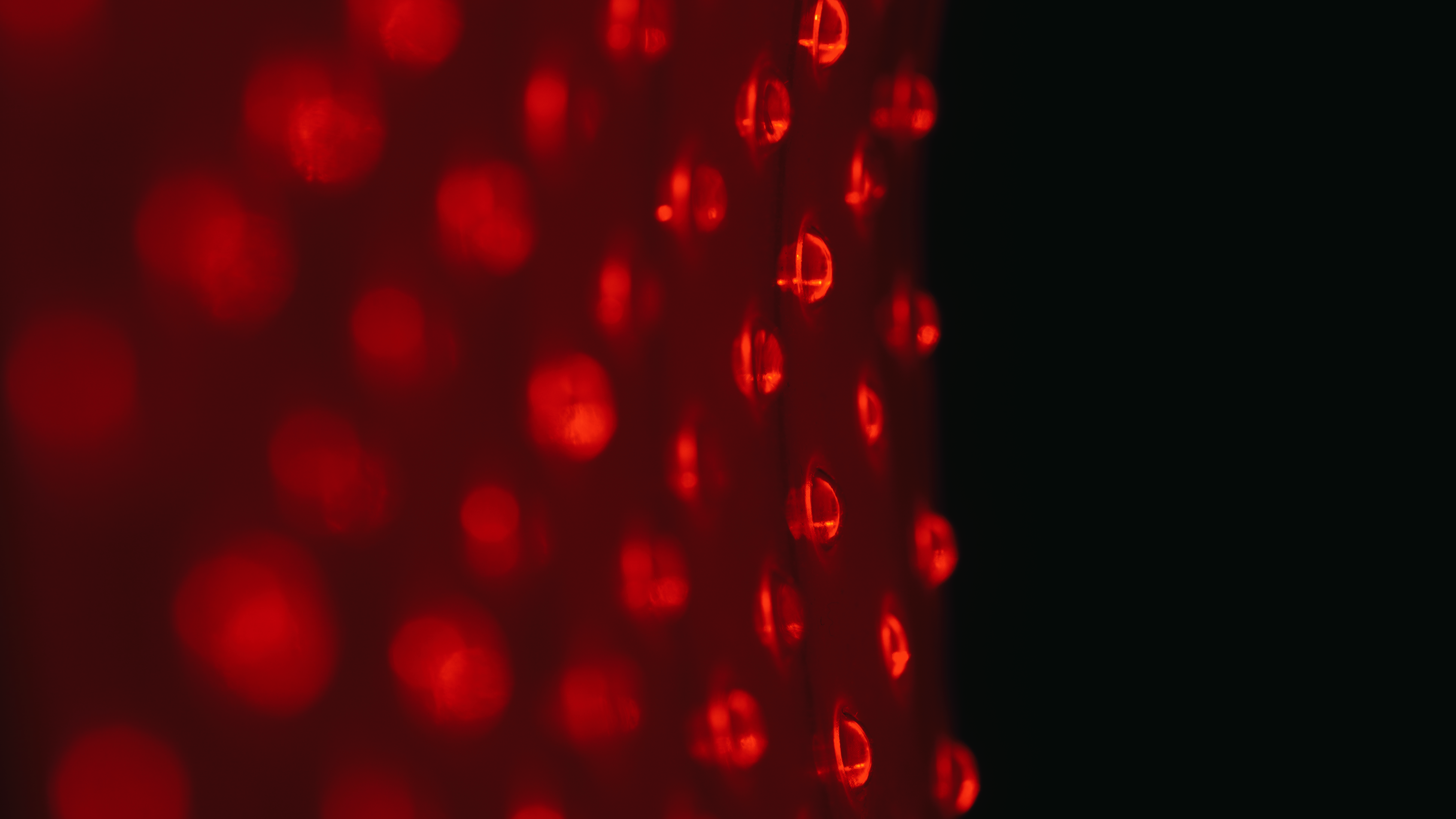Red bokeh lights on a dark background.