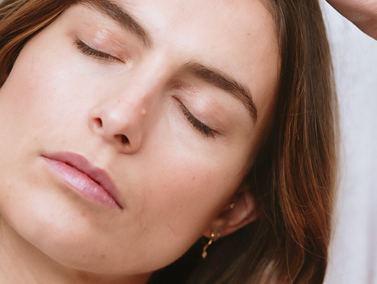 Close-up of a person with closed eyes and relaxed expression.