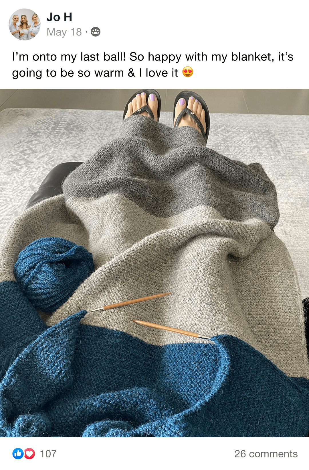 Handmade knitted blanket with brown, gray, and cream sections on a chair.