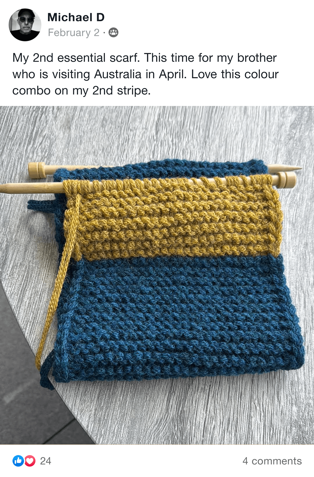 Handmade knitted blanket with brown, gray, and cream sections on a chair.