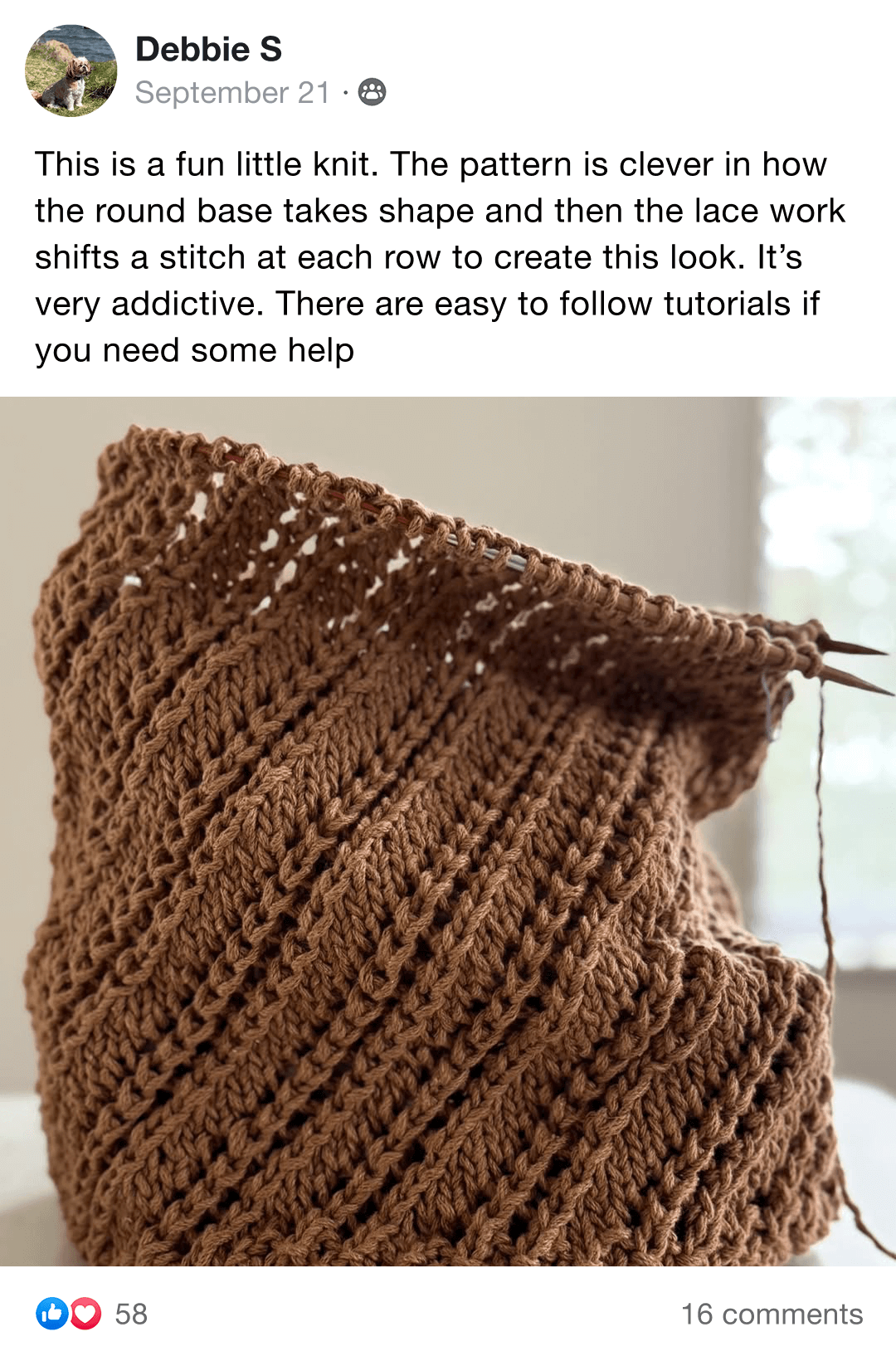Handmade knitted blanket with brown, gray, and cream sections on a chair.