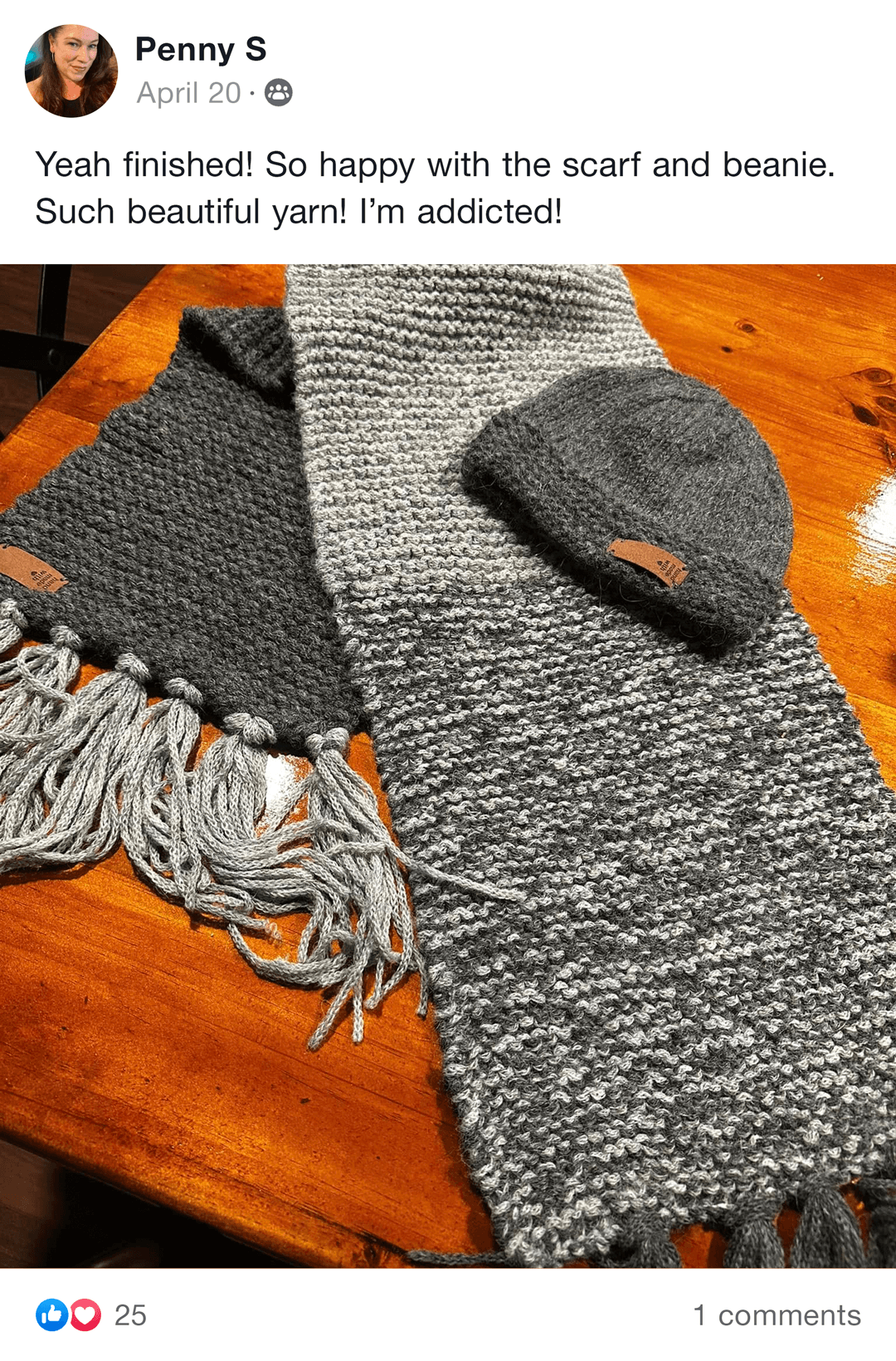 Knitting project with blue and beige yarns and knitting needles on a table.