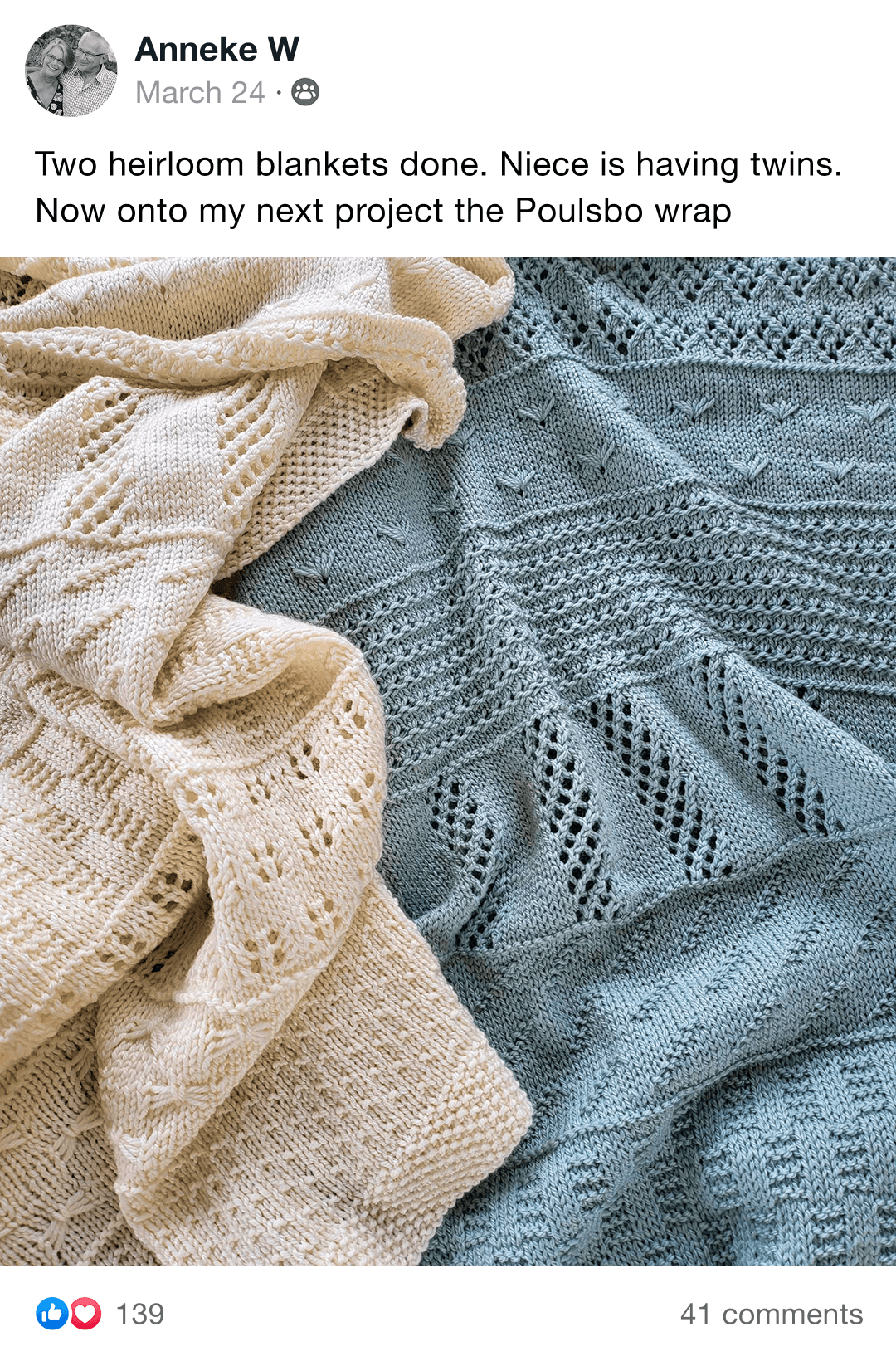 Two intricately knit blankets, one cream and one blue, folded together.