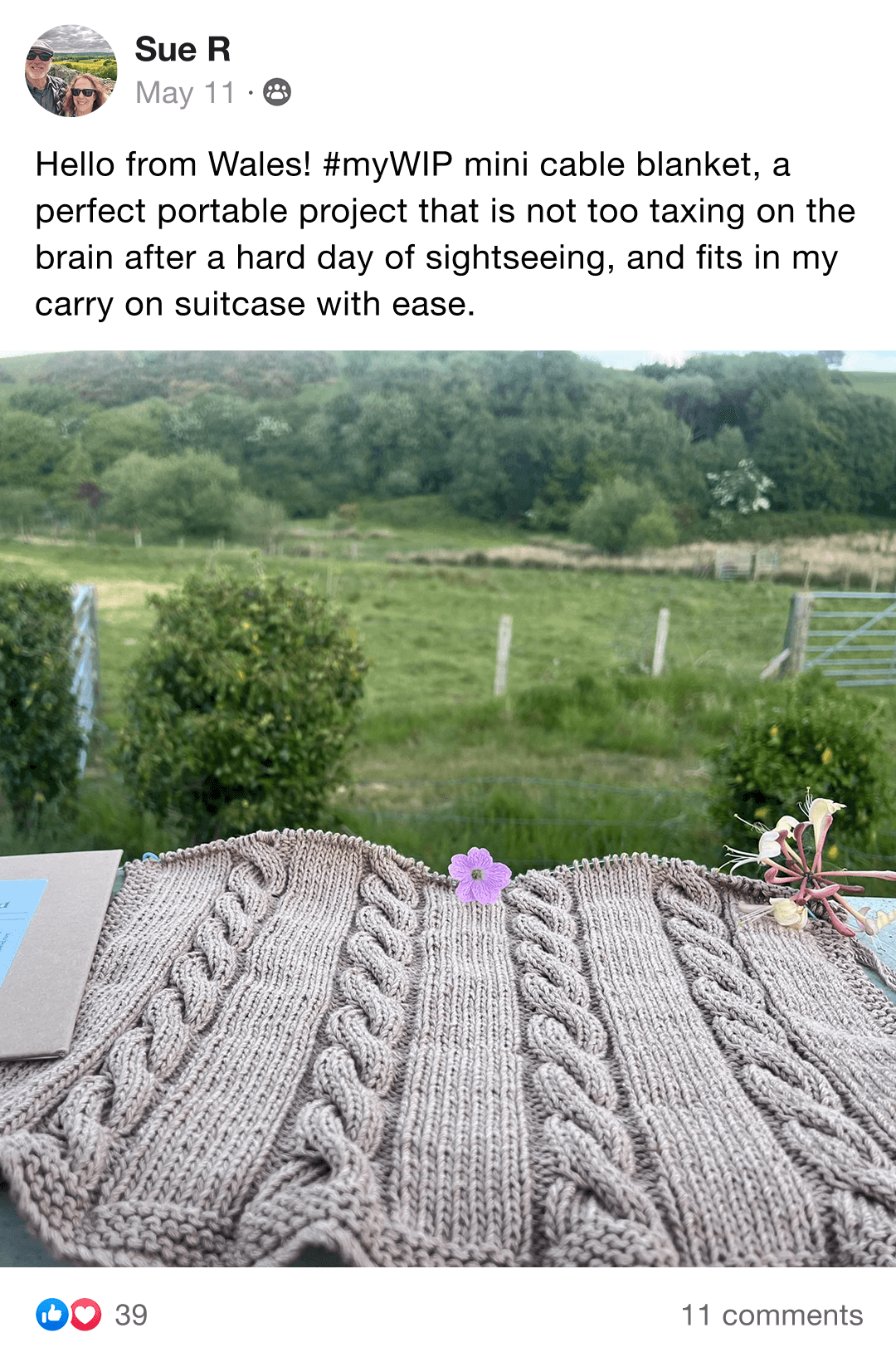 Two intricately knit blankets, one cream and one blue, folded together.
