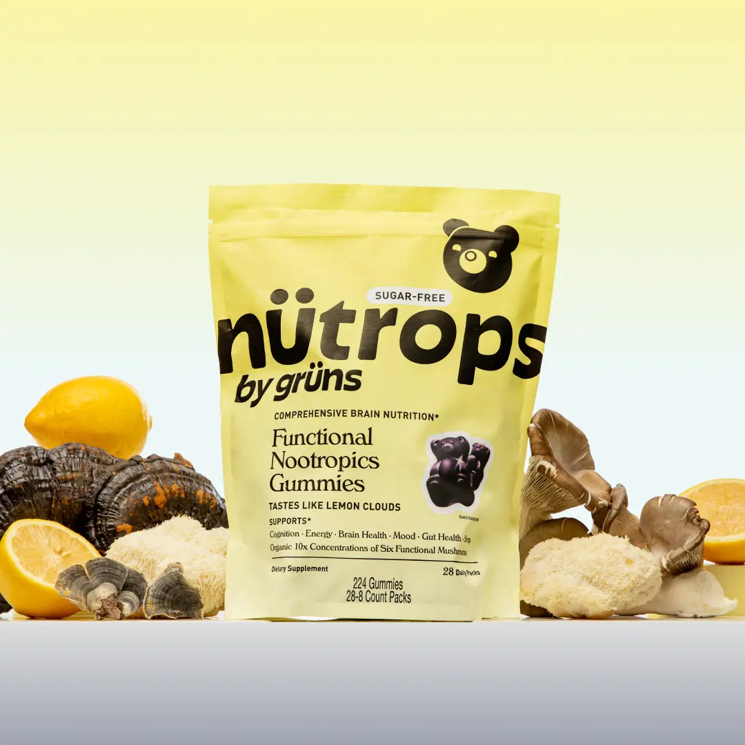 Bag of functional nootropics gummies surrounded by mushrooms and lemons.