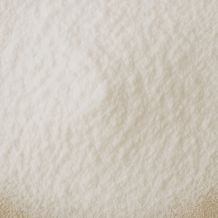 Close-up of a white, textured powder surface.