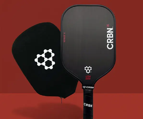 A black CRBN pickleball paddle and its matching cover are displayed against a red background.