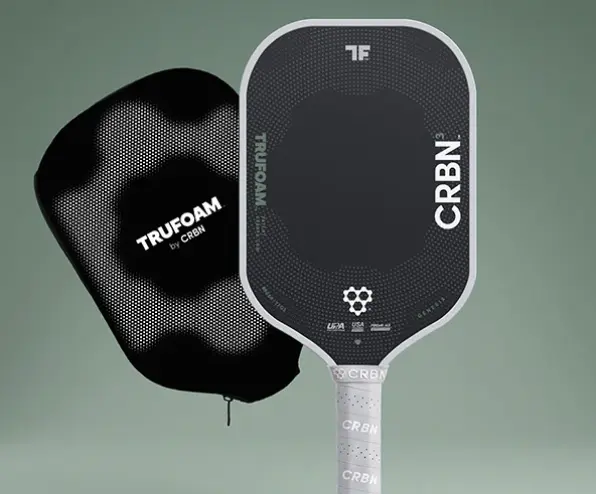 A black CRBN pickleball paddle with a white handle, shown next to its matching black protective cover.