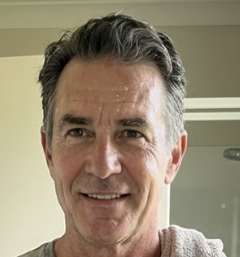 A circular portrait of a young East Asian woman with long dark hair against a dark background.