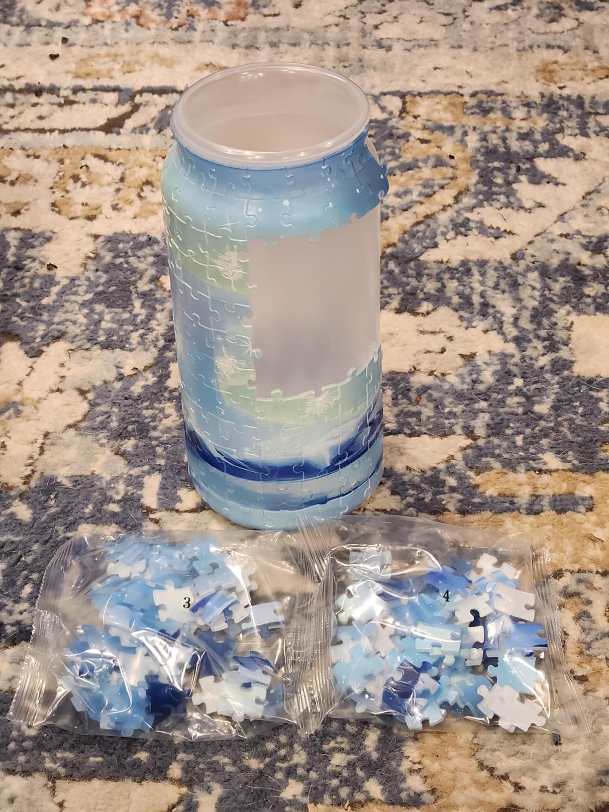 PieceRelax blue puzzle vase during assembly with numbered puzzle piece bags