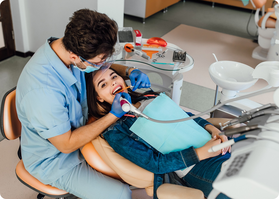 Dentist examining a patient's teeth in a dental clinic.