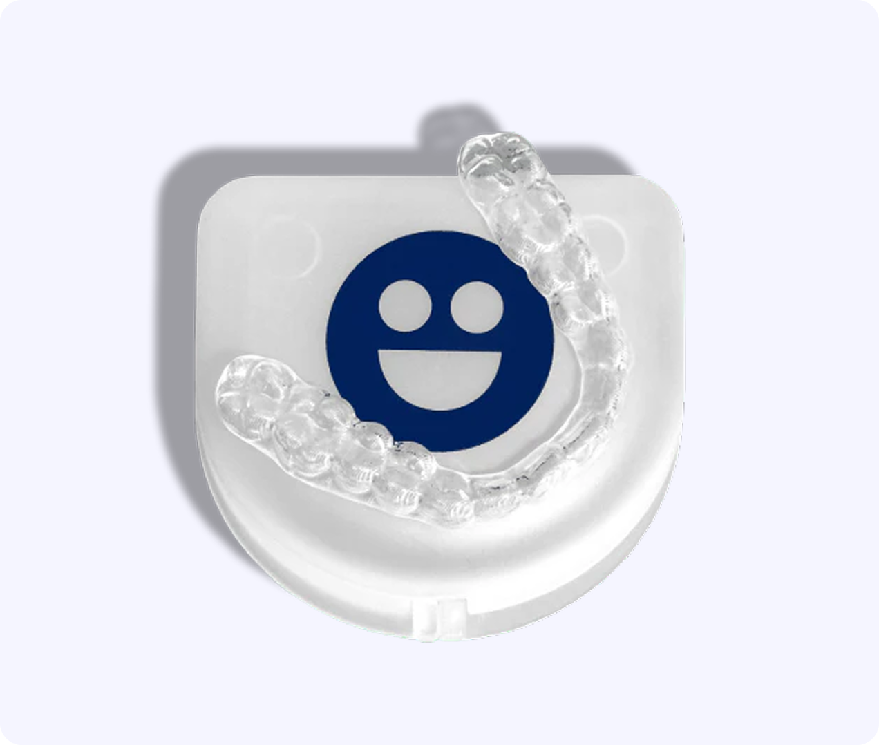 Clear dental aligner on a white case with a blue smiley face.