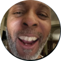 Close-up of a smiling man with a beard.