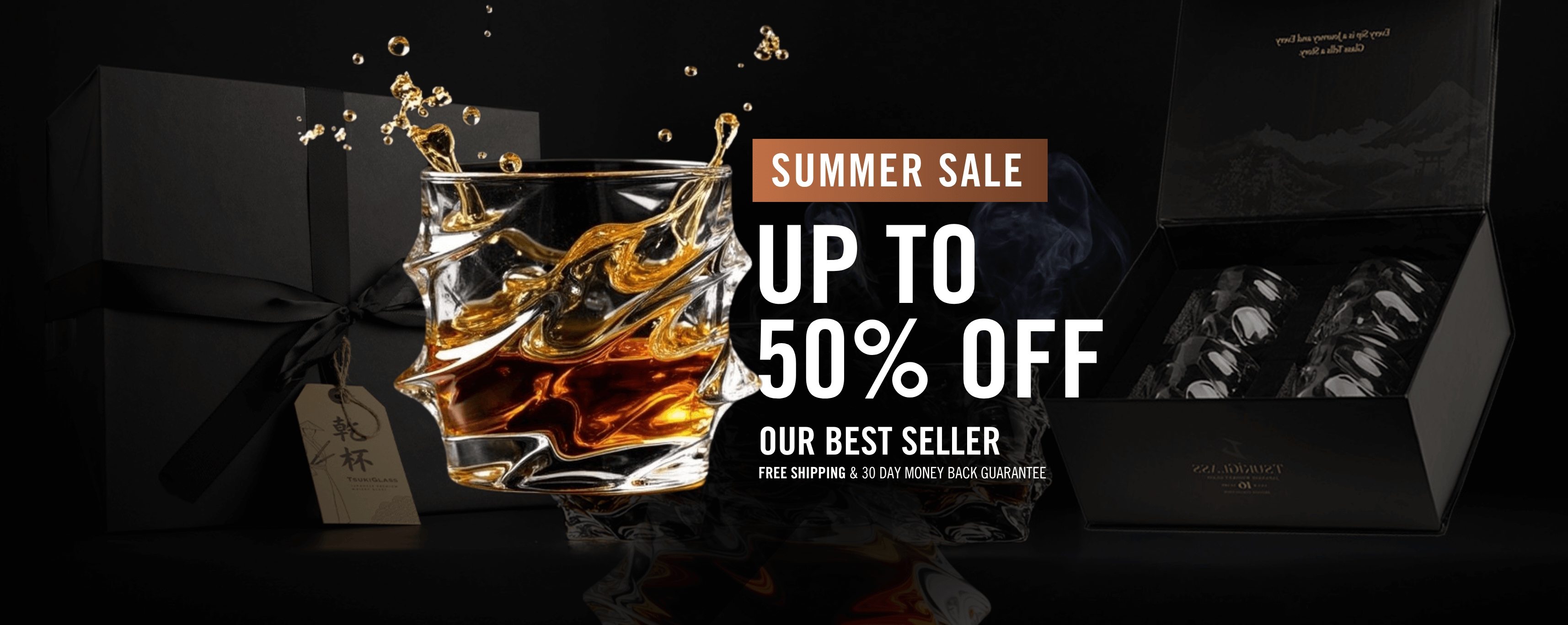 Whiskey glass with splash, black gift box, and sale text.