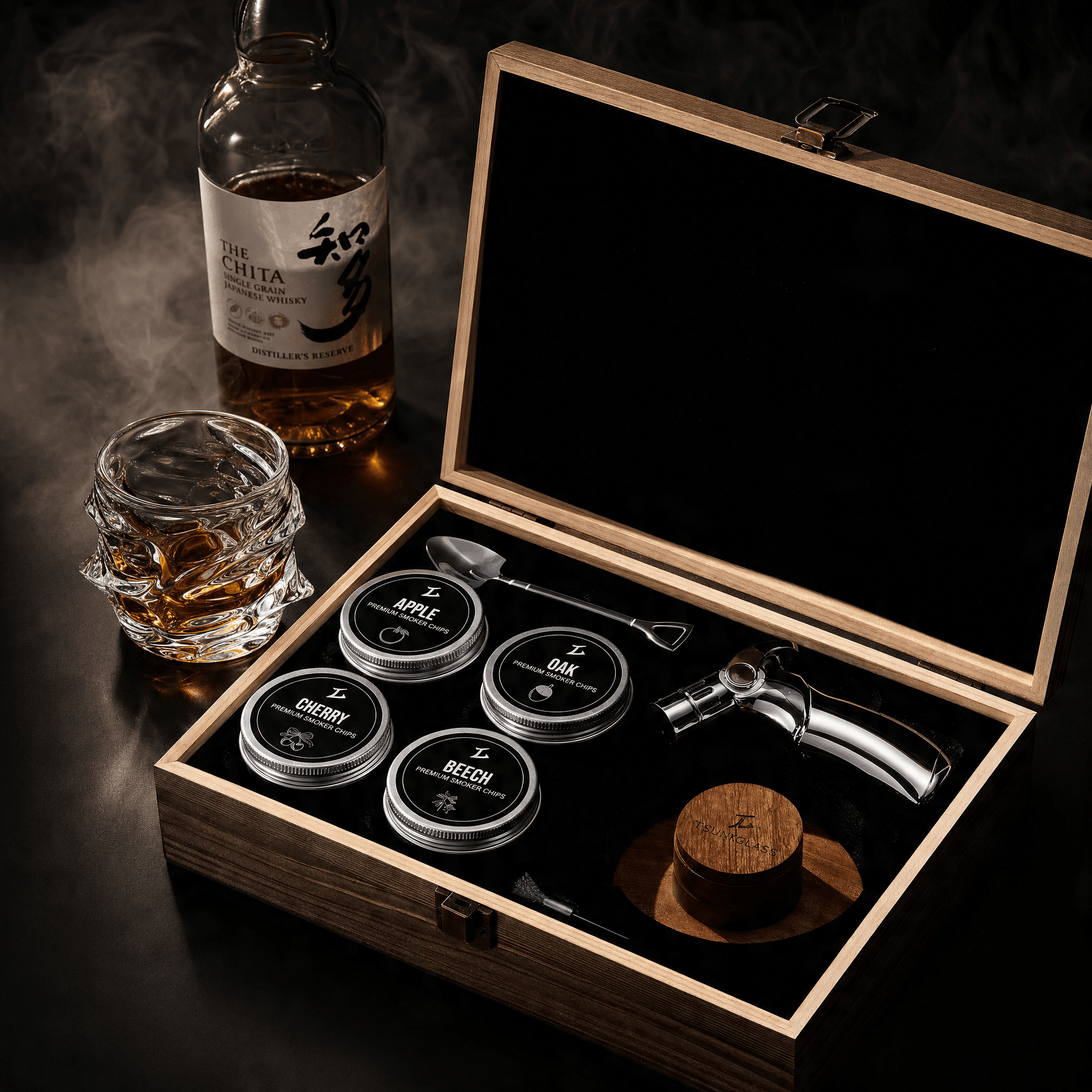 A cocktail smoker kit in a wooden box next to a bottle and a smoking glass of whisky.