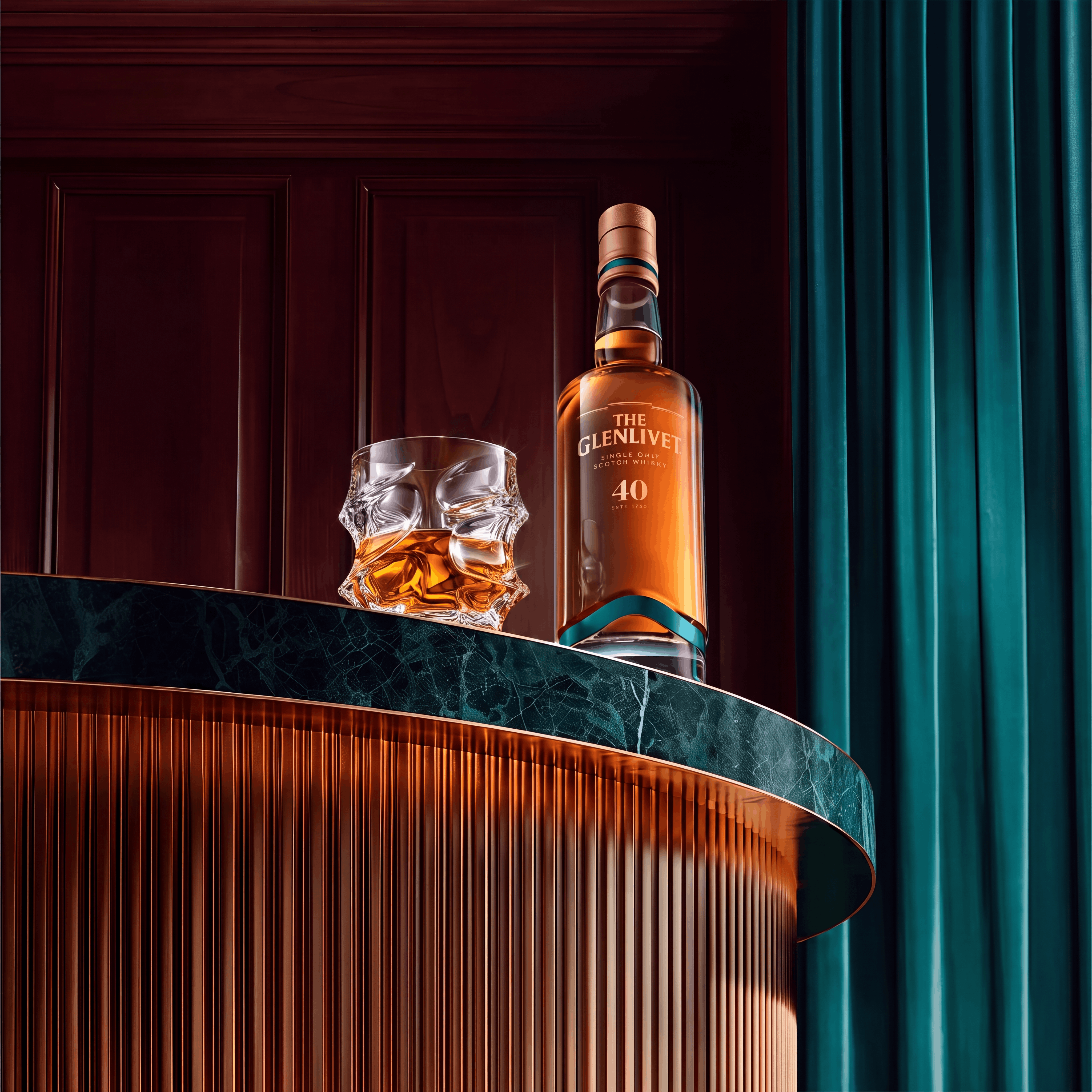 A bottle of The Glenlivet 40 whisky and a glass on an elegant, curved bar counter.