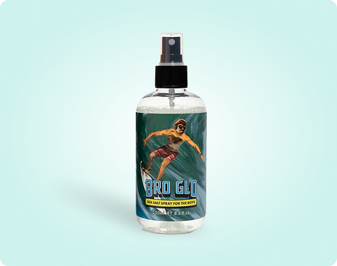 Clear spray bottle with a label featuring a surfer image and the text 'Bro Glo.'