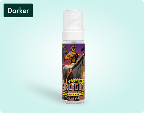 Bottle of self-tanning foam with a cartoon man on the label, against a light blue background.