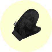 Black oven mitt on a light yellow background.