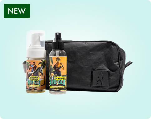 Two bottles with colorful labels and a black toiletry bag on a light background.