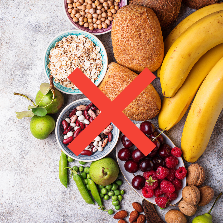 An overhead shot of fruits, grains, legumes, and nuts with a large red X crossed over them.