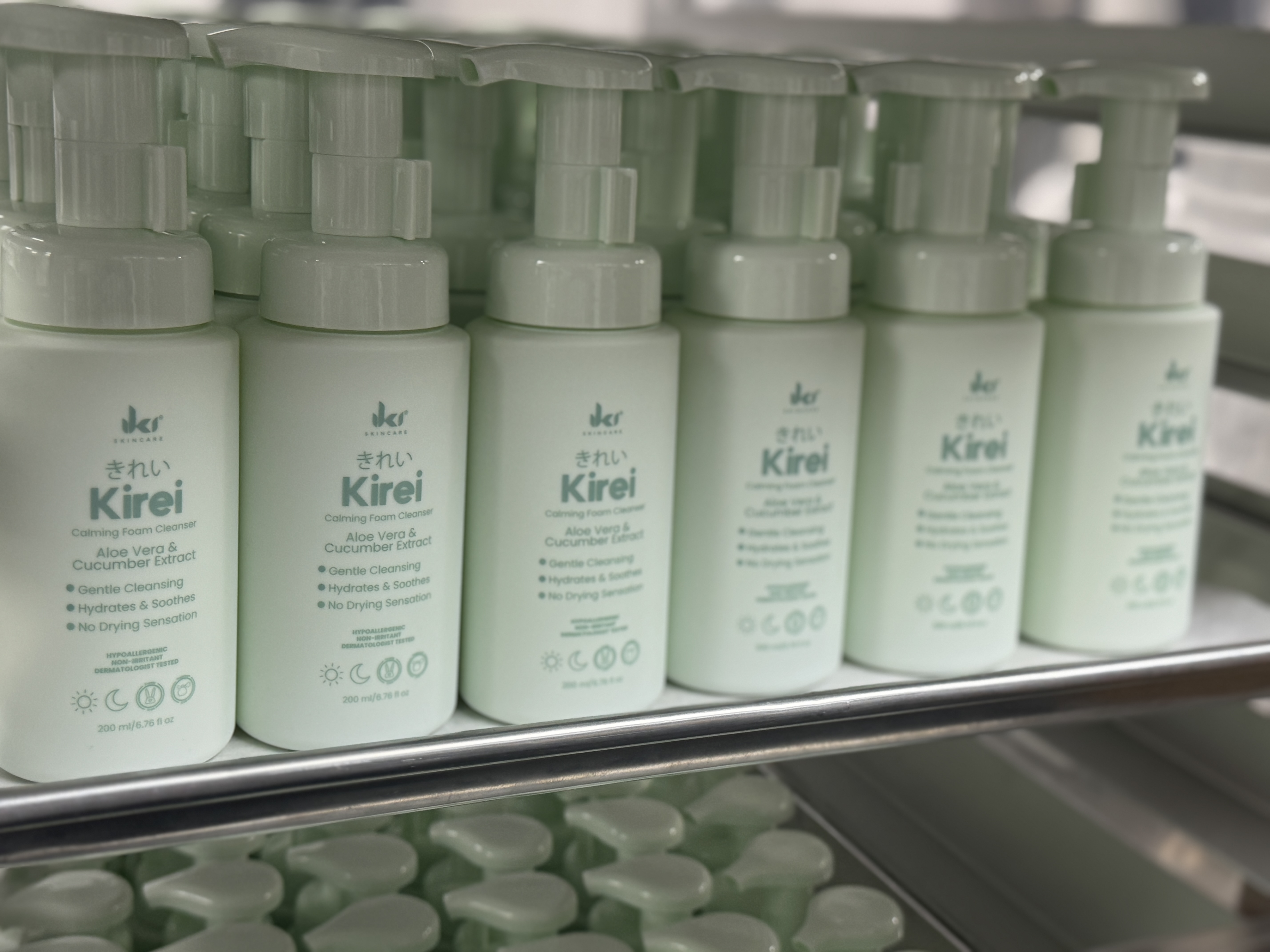 Rows of light green bottles labeled 'Kirei' on a shelf.