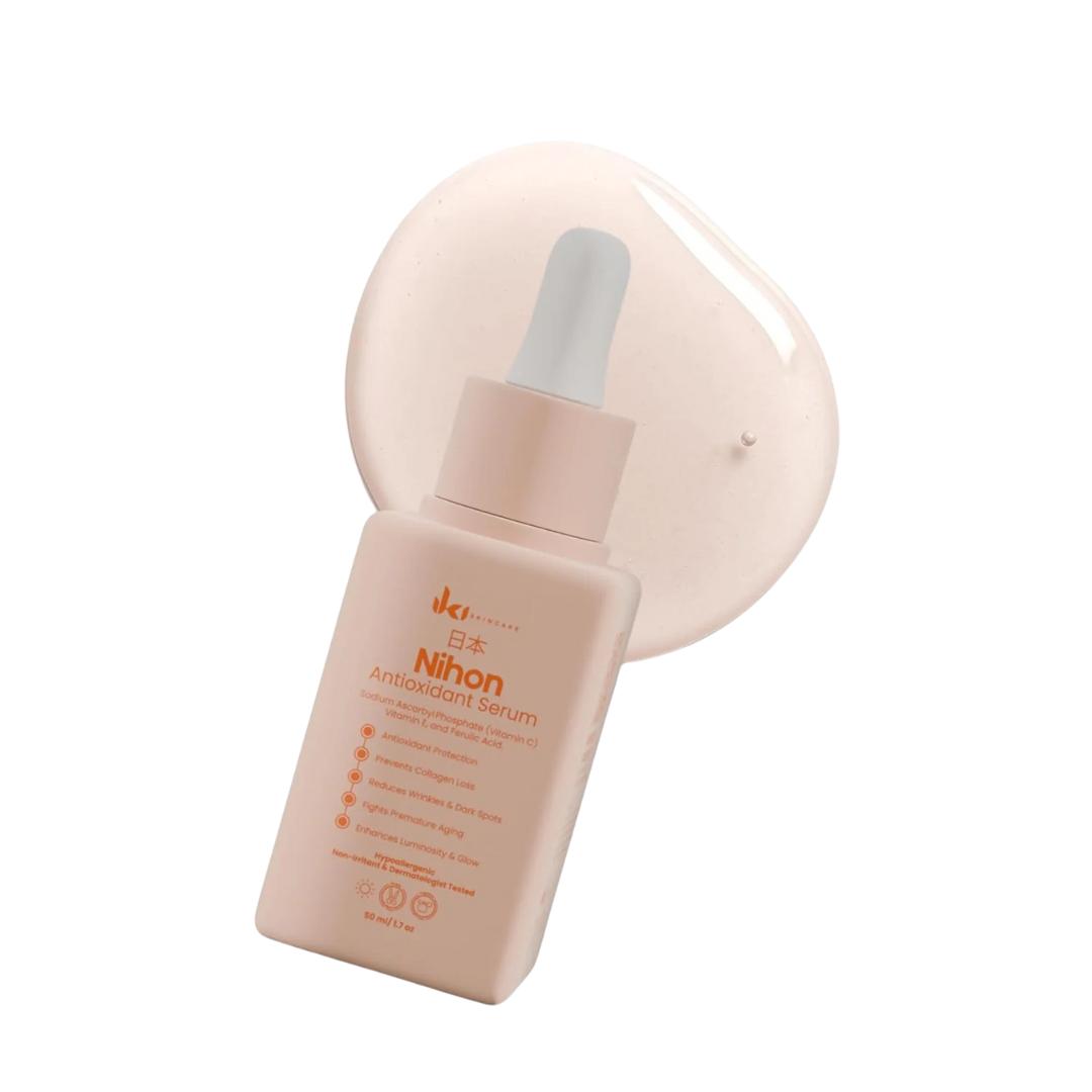 White lotion bottle with a pump next to green plant leaves on a geometric background.