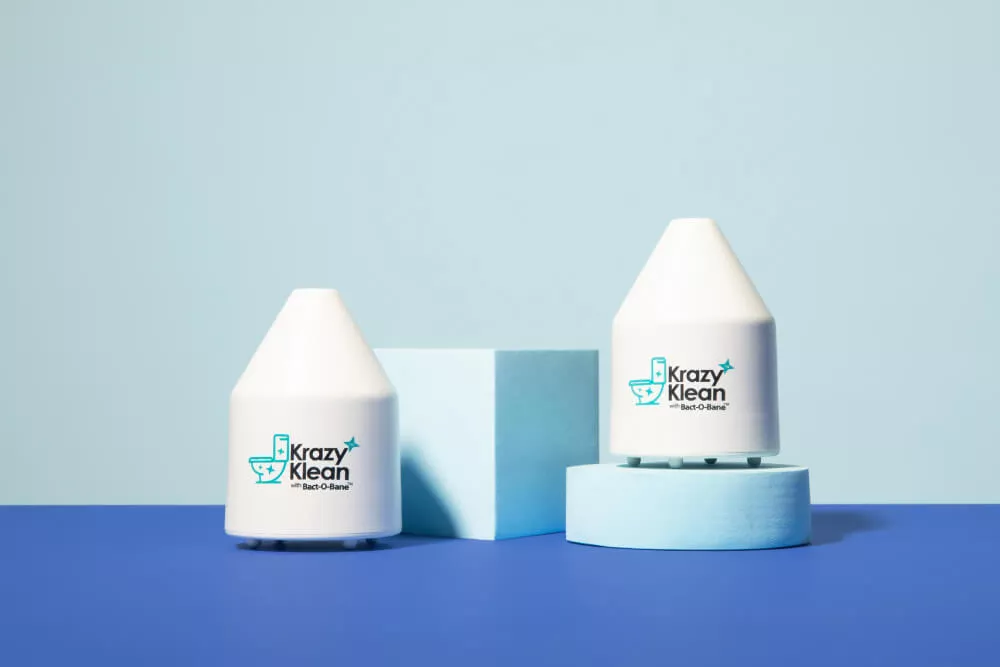 Two Krazy Klean devices on blue geometric shapes.