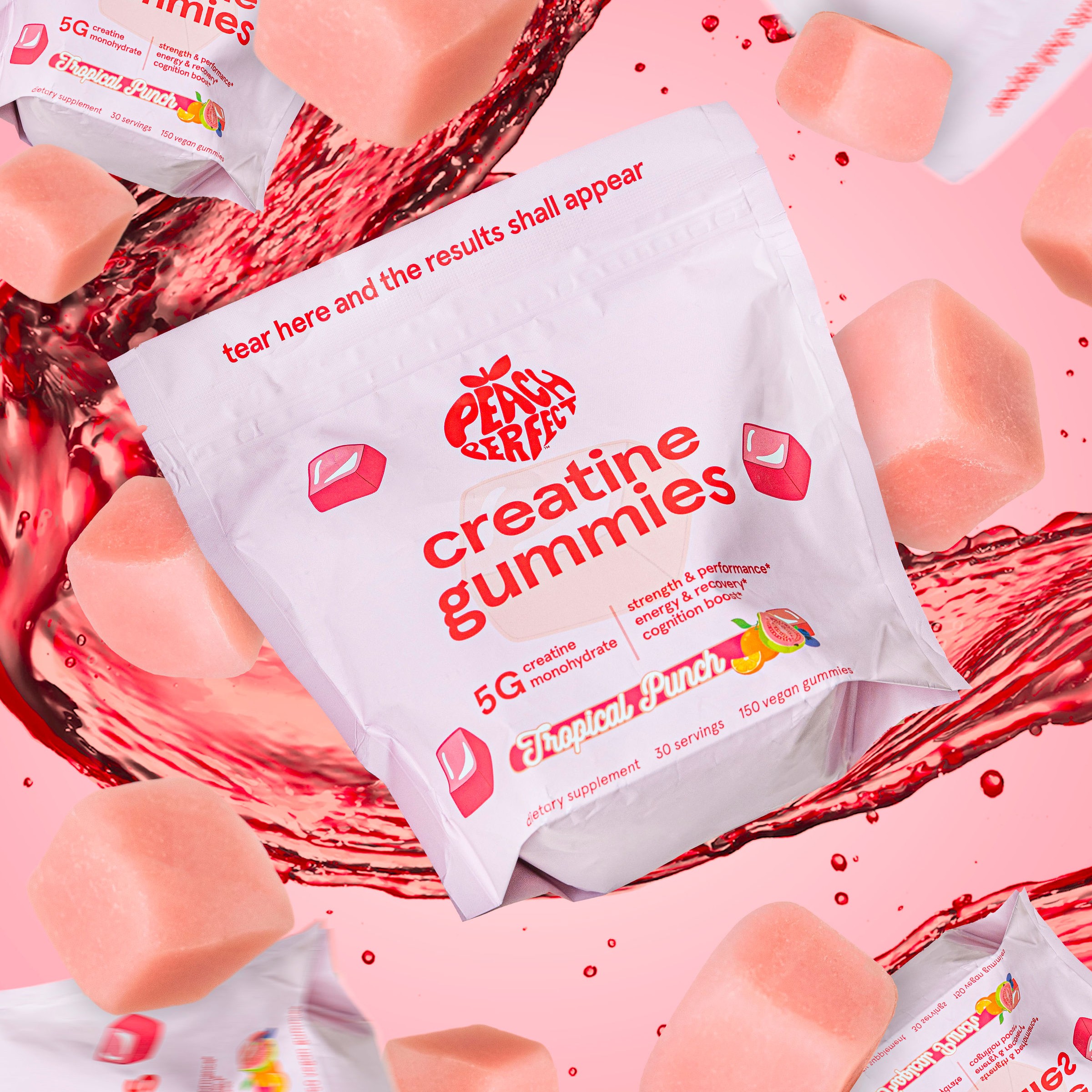 A white pouch of Peach Perfect creatine gummies surrounded by floating pink gummies and splashes of red liquid.