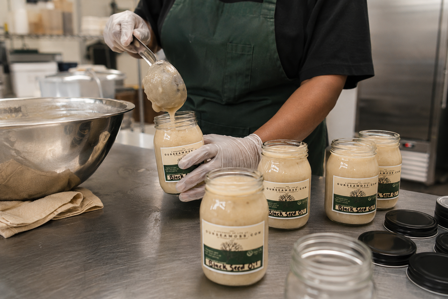 Sea moss gel being filled into jars by hand