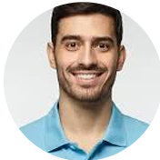 Smiling man in a blue shirt against a plain background.