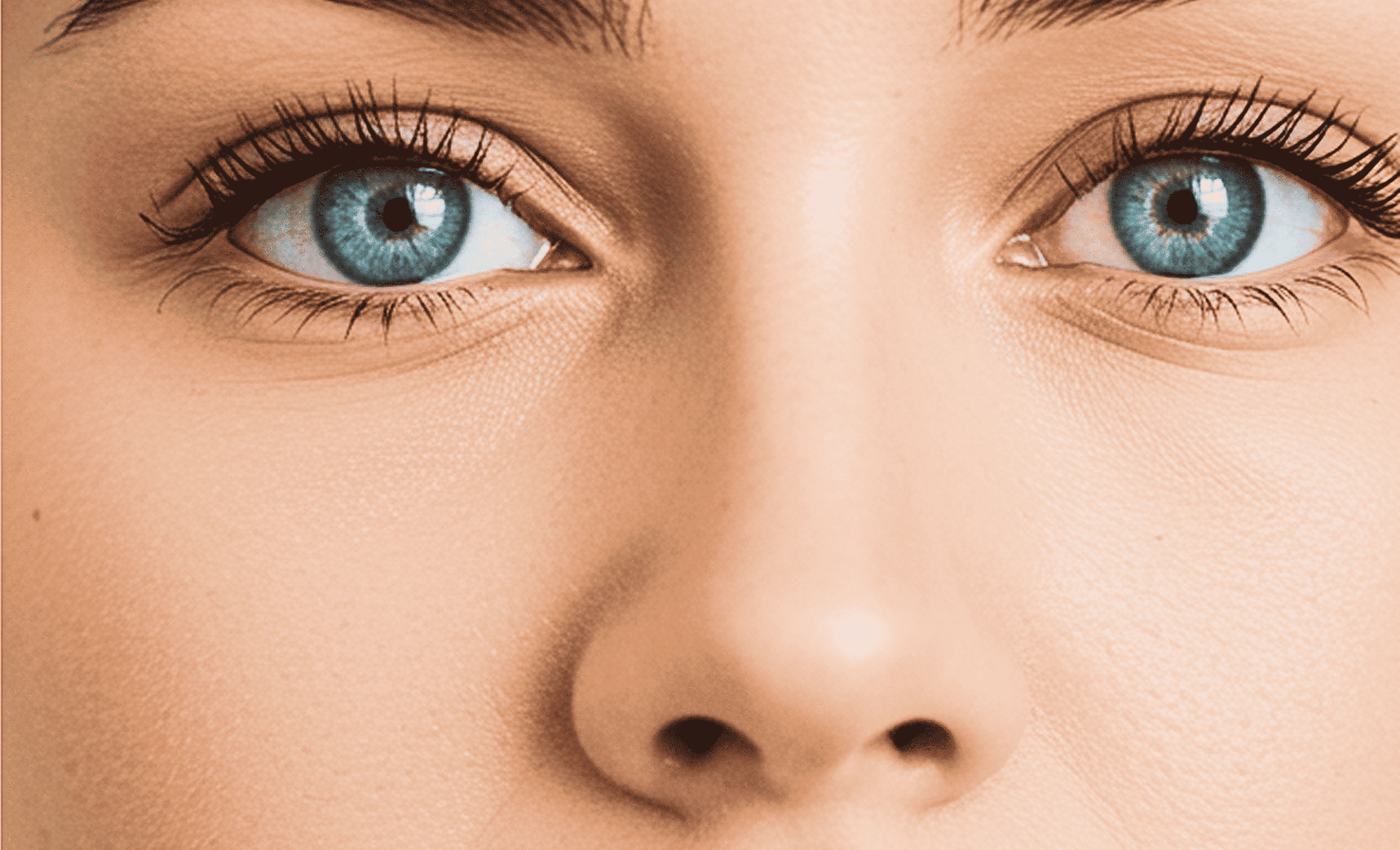 Close-up of a person's blue eyes and nose.
