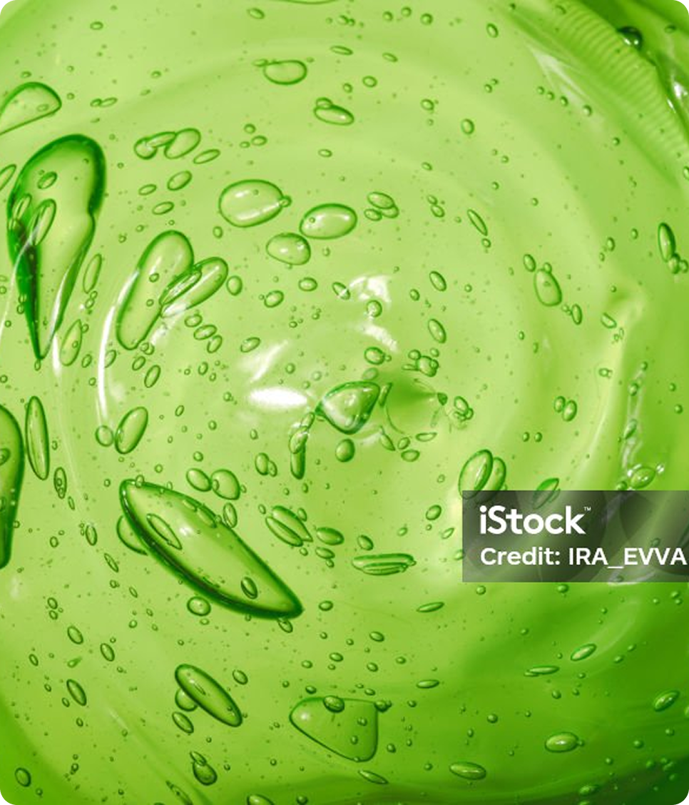 A close-up, top-down view of a swirling, bright green transparent gel with many air bubbles.