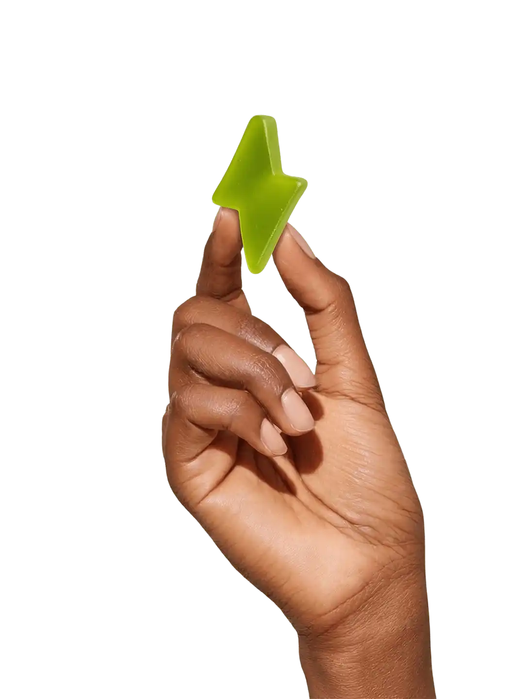 A hand with light-colored nails holds up a translucent green, lightning-bolt-shaped gummy against a white background.