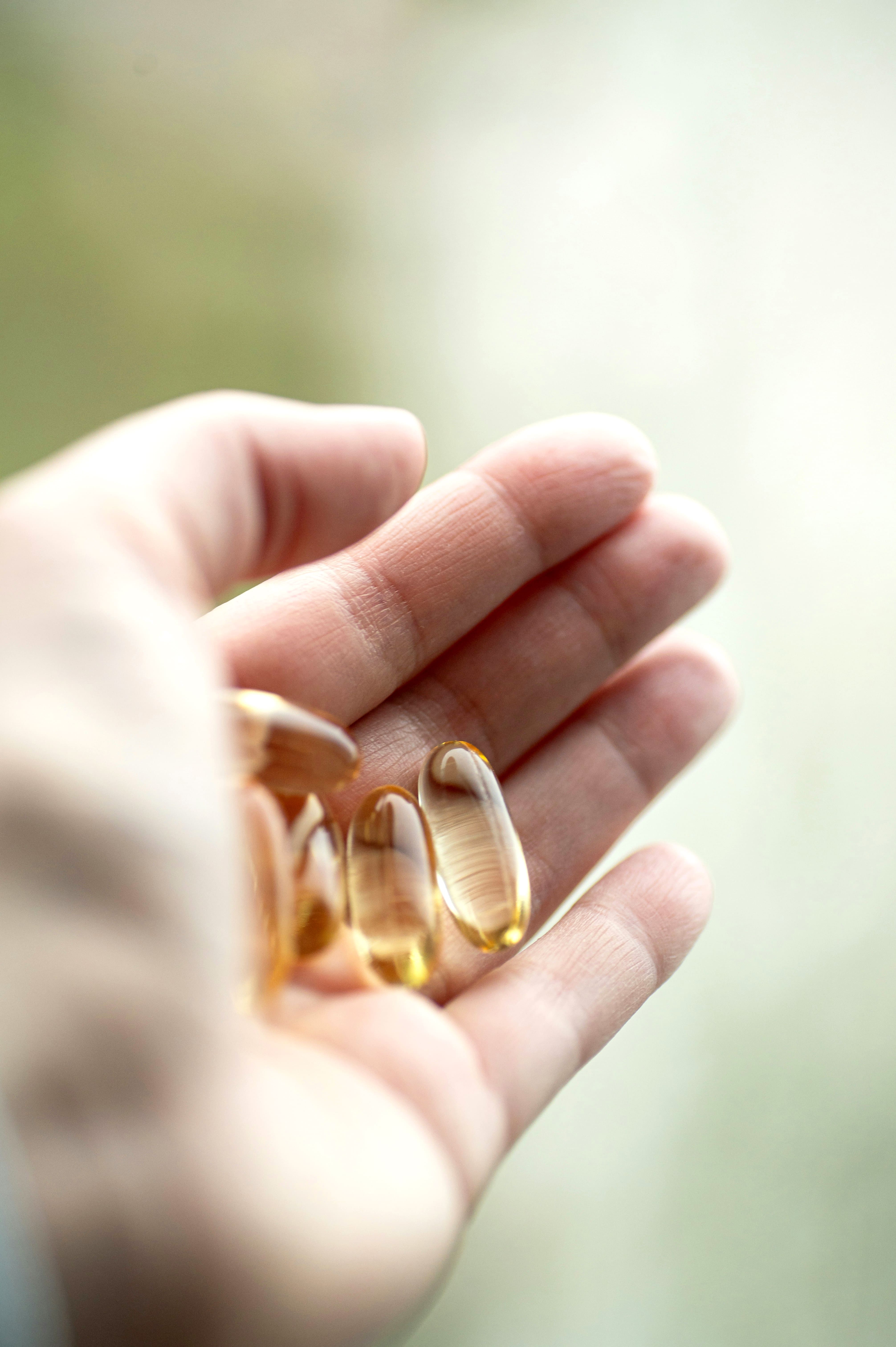 Hand holding couple Omega-3 softgel