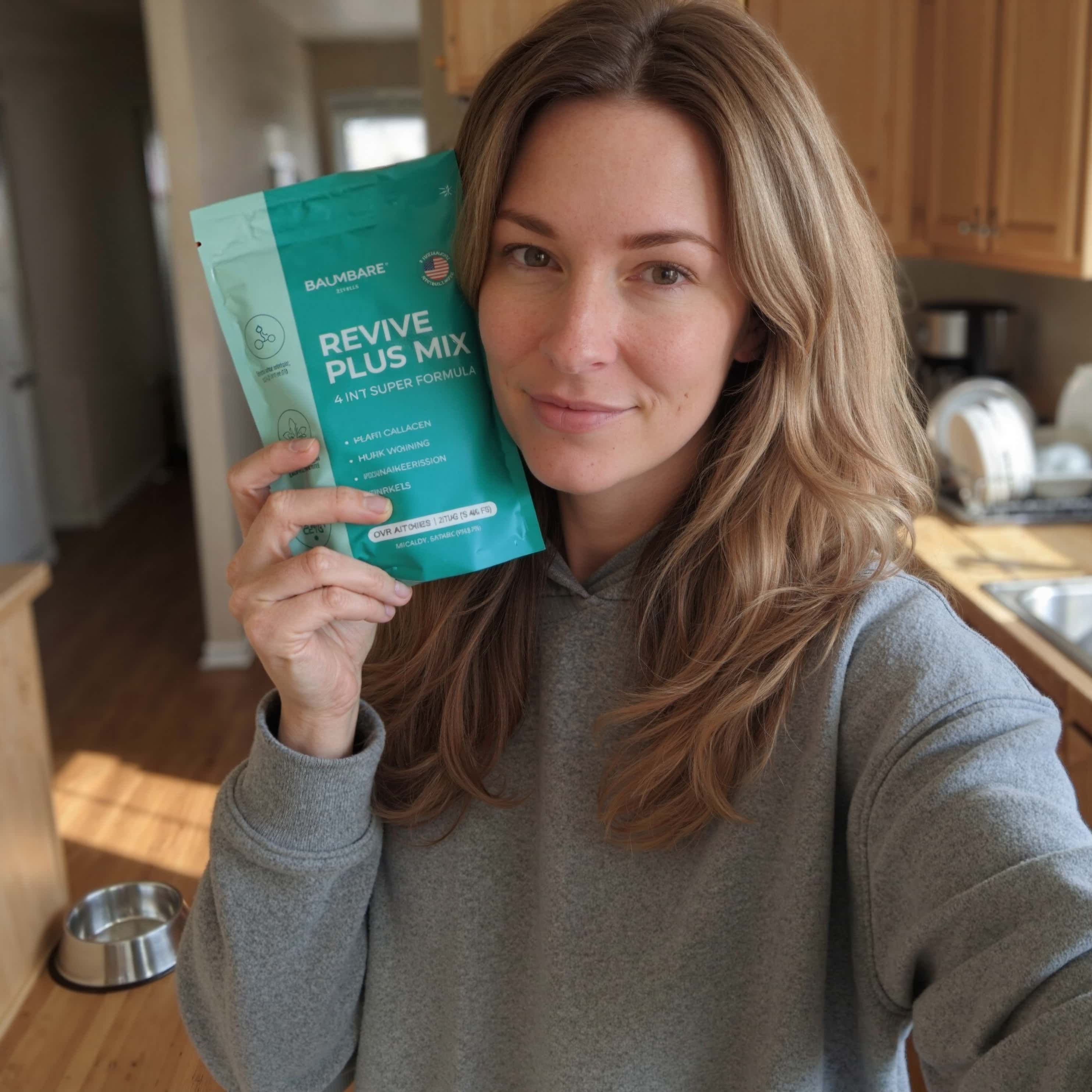 Person holding a packet of 'Revive Plus Mix' in a kitchen.