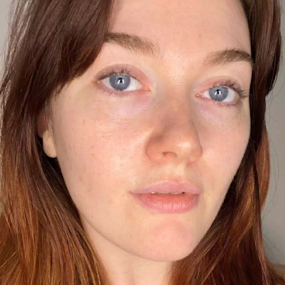 Close-up of a person with blue eyes and brown hair.