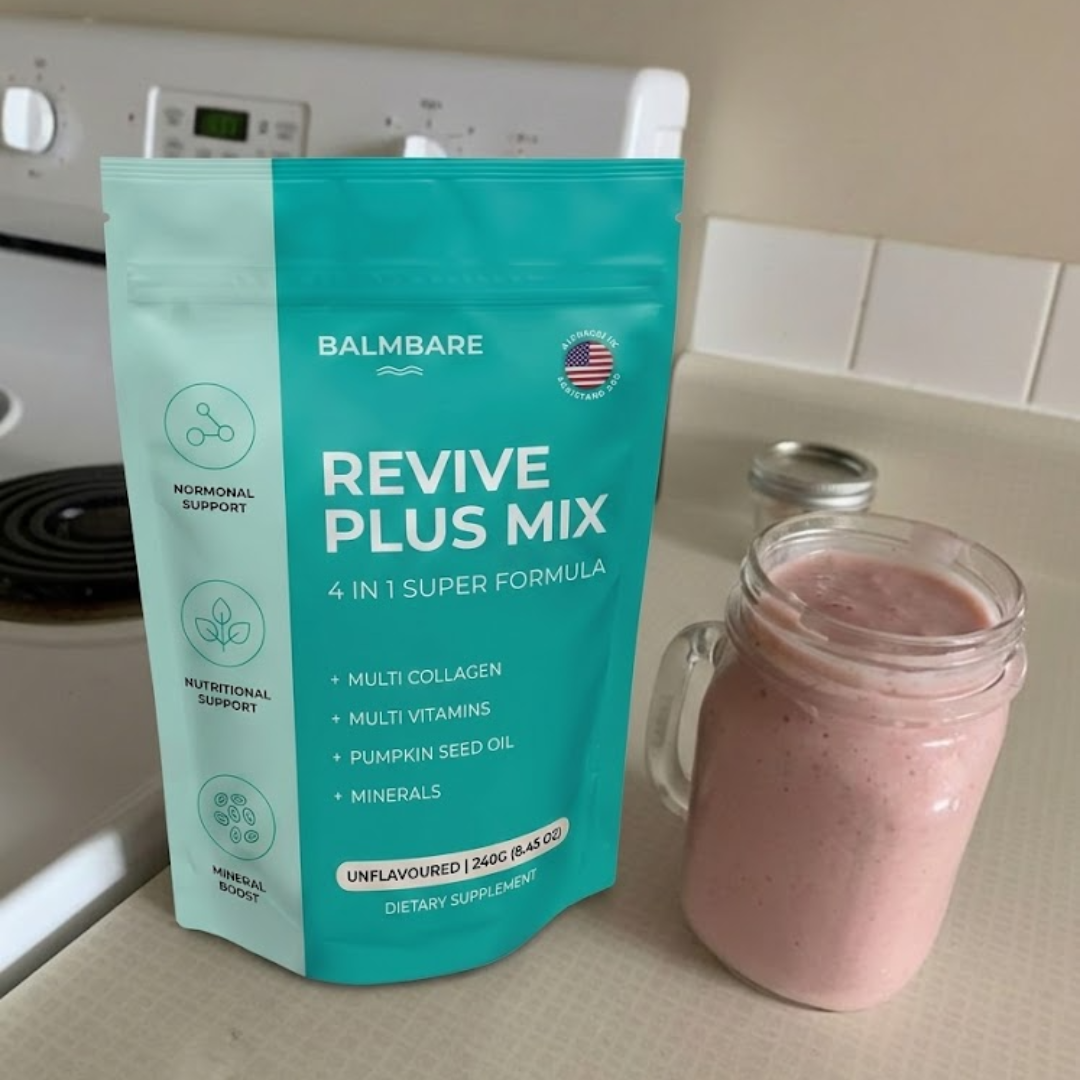 A pouch of BalmBare Revive Plus Mix dietary supplement next to a pink smoothie in a glass mug.
