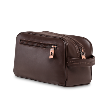 A brown leather toiletry bag with zippers and a handle, shown against a white background.