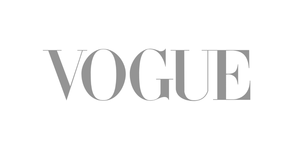 Gray 'VOGUE' logo on a transparent background.