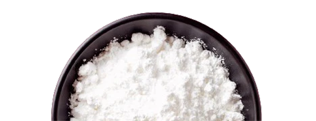 A black bowl filled with white powder on a white background.