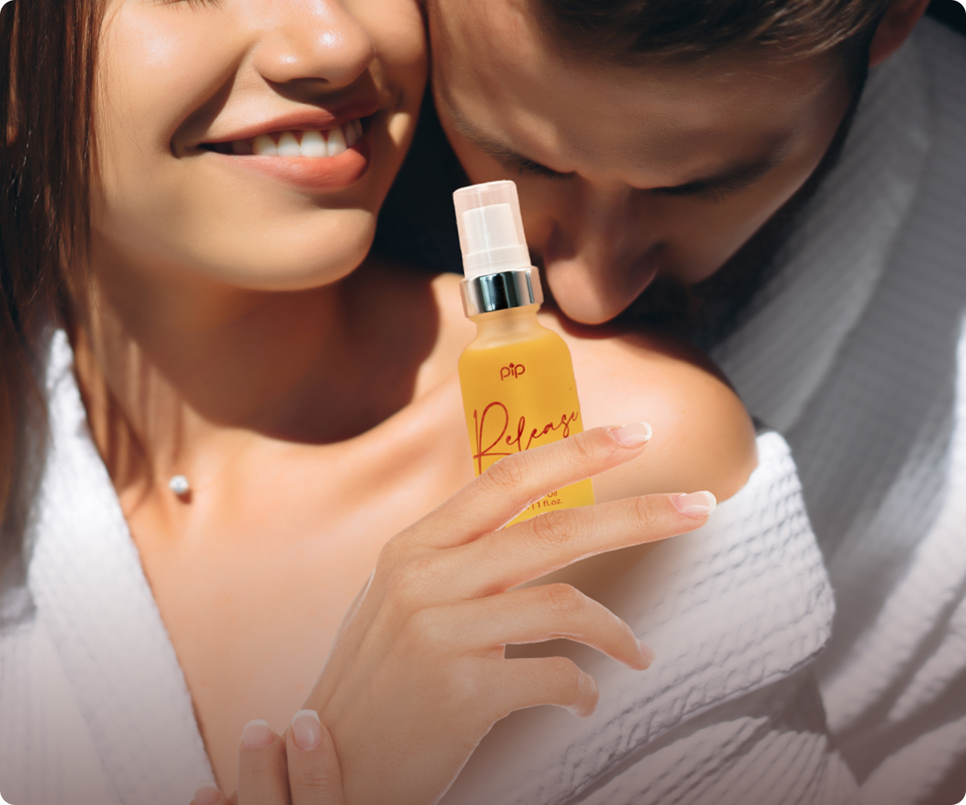 Close-up of a couple with a woman holding a yellow spray bottle.