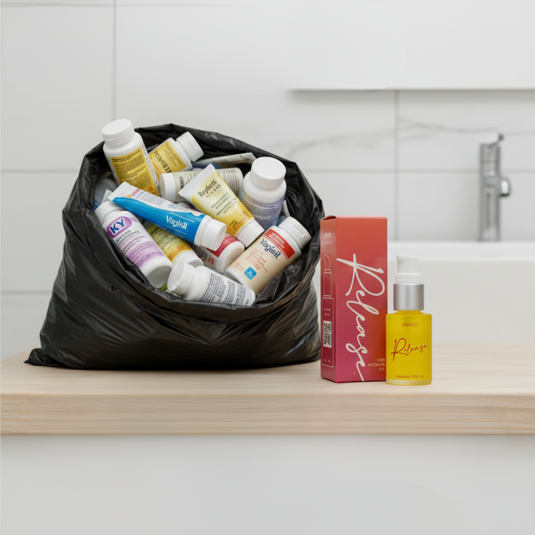 A black trash bag full of intimacy products sits next to a new bottle and box of 'Release' oil.
